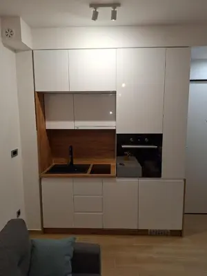a kitchen with white cabinets and a sink at Banja Residence Apt in Tuzla