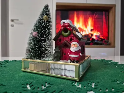 a figurine of a santa in a gingerbread house with a fireplace at Banja Residence Apt in Tuzla