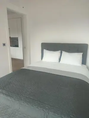 a bedroom with a large bed with white pillows at Banja Residence Apt in Tuzla