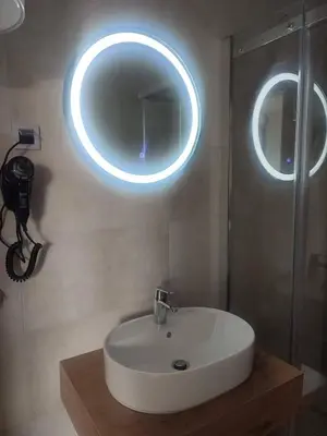 a bathroom with a sink and a mirror on the wall at Banja Residence Apt in Tuzla