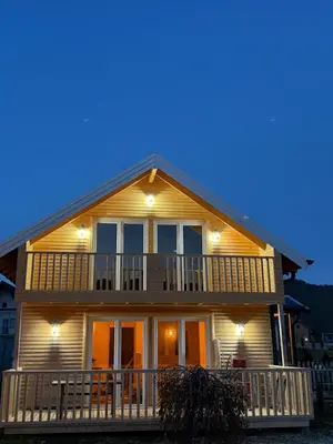 a house with a porch and lights on it at Vlasic Odmor - Villa Amina in Vlasic