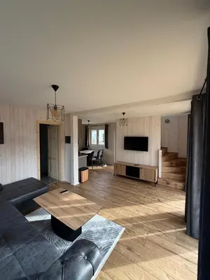 a living room with a couch and a table at Vlasic Odmor - Villa Amina in Vlasic