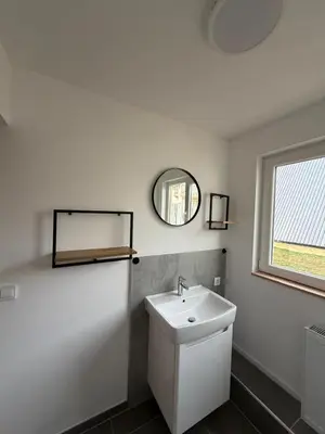 a white bathroom with a sink and a mirror at Vlasic Odmor - Villa Amina in Vlasic