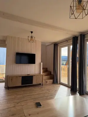 a living room with a flat screen tv on a wall at Vlasic Odmor - Villa Amina in Vlasic