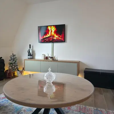 a living room with a table with a tv on the wall at MaLi Raj in Vlasic