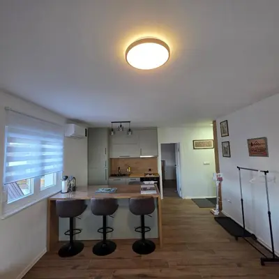 a kitchen with a counter and two bar stools at MaLi Raj in Vlasic