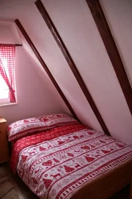 a bed in a room with avertisement at Apartmani Ciro in Kupres