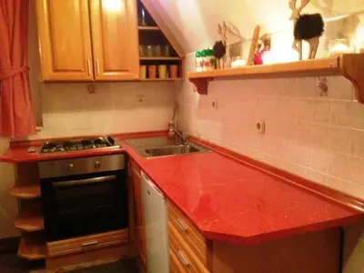 a kitchen with a red counter top and a sink at Kuća za odmor Vukas in Kupres