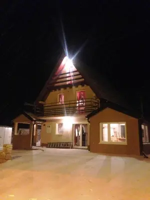 a building with a light on top of it at night at Kuća za odmor Vukas in Kupres