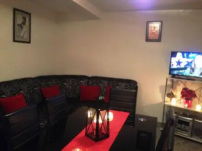 a living room with a couch and a television at Kuća za odmor Vukas in Kupres