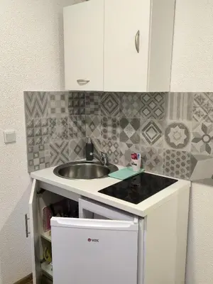 a kitchen with a sink and a counter top at TOKIs apartmani in Mrkonjić Grad