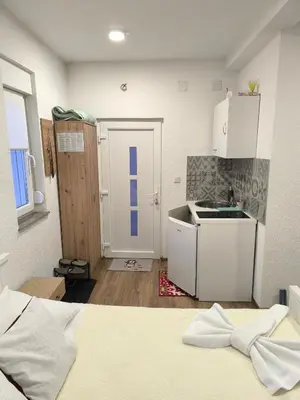 a small kitchen with a sink and a counter at TOKIs apartmani in Mrkonjić Grad