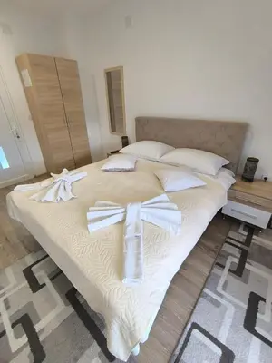 a large bed with bows on it in a bedroom at TOKIs apartmani in Mrkonjić Grad
