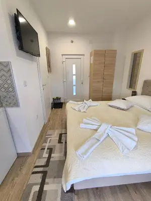 a room with two beds with towels on them at TOKIs apartmani in Mrkonjić Grad