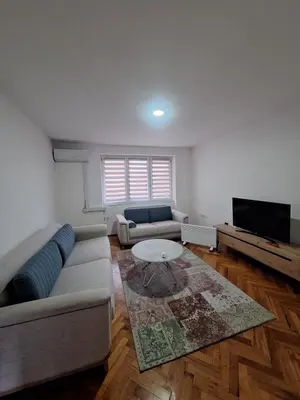 a living room with a couch and a table at Apartman Mila in Bihać