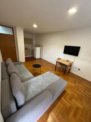 a living room with a couch and a flat screen tv at Jedinica in Banja Luka