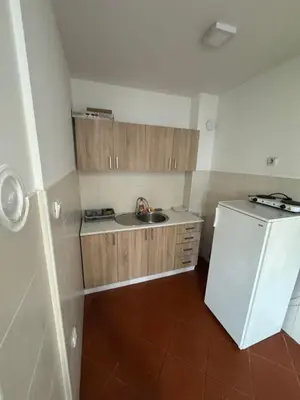 a small kitchen with a sink and a white refrigerator at Jedinica in Banja Luka