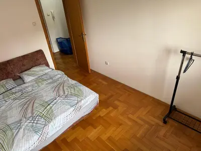 a bedroom with a bed and a tripod in it at Jedinica in Banja Luka