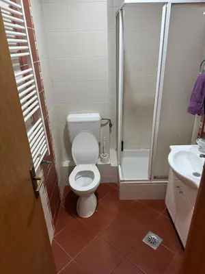 a bathroom with a toilet and a shower and a sink at Jedinica in Banja Luka