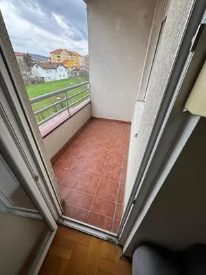 a room with a balcony with a tiled floor at Jedinica in Banja Luka
