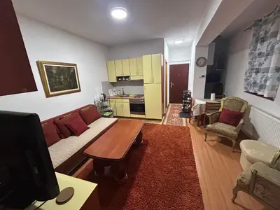 a living room with a couch and a table at Vlašić Forest Valley in Vlasic