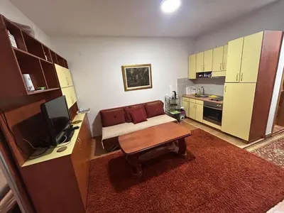 a living room with a couch and a table at Vlašić Forest Valley in Vlasic