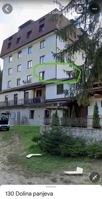 a large white building with a red roof at Vlašić Forest Valley in Vlasic