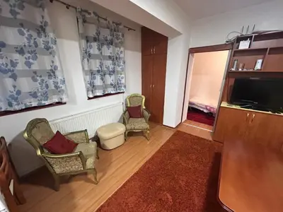 a living room with two chairs and a flat screen tv at Vlašić Forest Valley in Vlasic