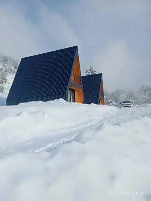 a house covered in snow with a pile of snow at Cottage Soul Rest