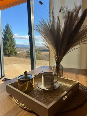 a tray with two cups on a table with a window at Cottage Soul Rest