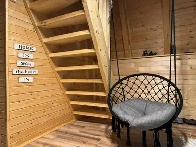 a swinging chair in a room with stairs at Cottage Soul Rest