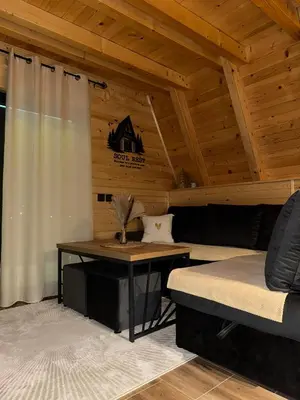 a room with a couch and a table in a cabin at Cottage Soul Rest