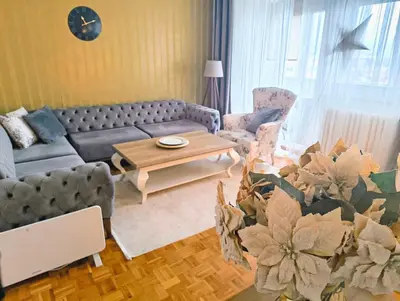 a living room with a couch and a table at City Center Apartment in Banja Luka