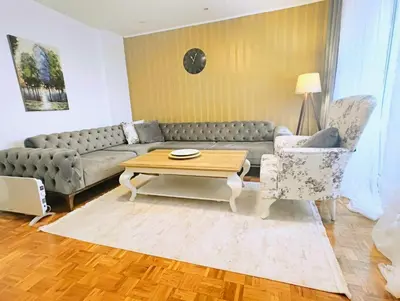 a living room with a couch and a coffee table at City Center Apartment in Banja Luka