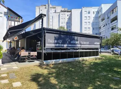 a building with a black awning in a city at City Center Apartment in Banja Luka