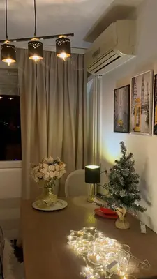 a room with a table with a christmas tree on it at City Center Apartment in Banja Luka