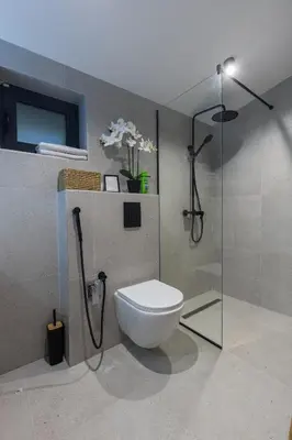 a bathroom with a toilet and a shower at BLOK Wood Cottage in Ivišovo Greblje