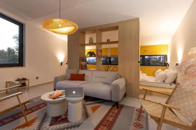 a living room with a couch and a table at BLOK Wood Cottage in Ivišovo Greblje