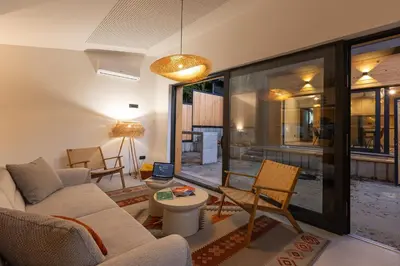 a living room with a couch and a table at BLOK Wood Cottage in Ivišovo Greblje