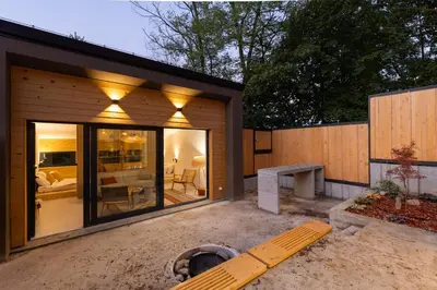 a small house with a large sliding glass door at BLOK Wood Cottage in Ivišovo Greblje