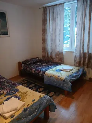 a room with two beds and a window at Apartment Snow Vlašić in Šišava