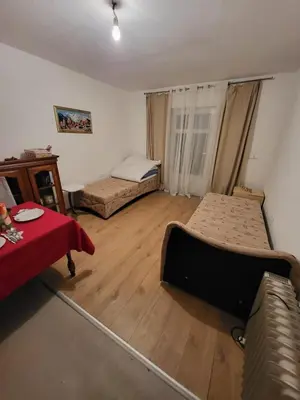 a room with two beds and a couch in it at Studio apartman 