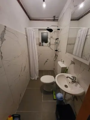 a bathroom with a toilet and a sink at Studio apartman 