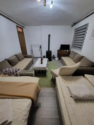 a living room with couches and a table at Studio apartman 