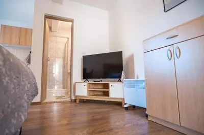 a living room with a television and a dresser at Biser Kupresa 2 in Kupres