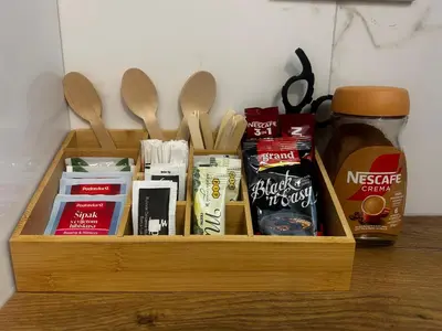 a wooden box with spices and spoons on a table at SteLa Apartman in Banja Luka