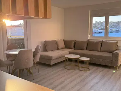 a living room with a couch and a table at Apartman Jaćimović in Doboj