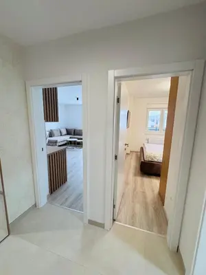 a room with a door open to a living room at Apartman Jaćimović in Doboj