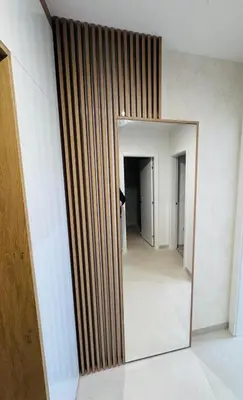 a mirror on a wall in a hallway at Apartman Jaćimović in Doboj