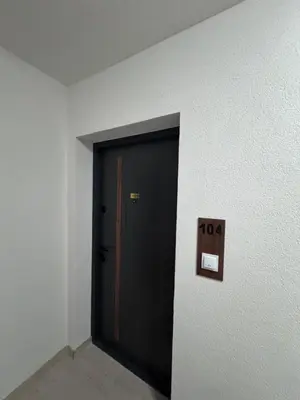 a black door with a sign on a wall at Apartman Jaćimović in Doboj